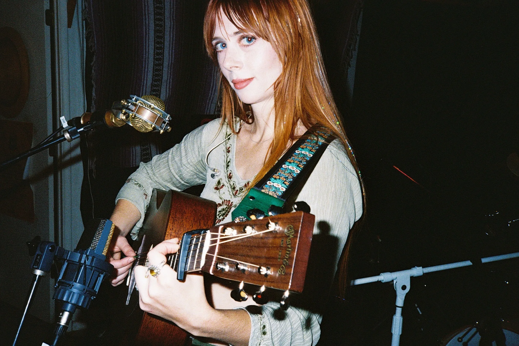 Autumn Cooper plays acoustic guitar in a recording session.